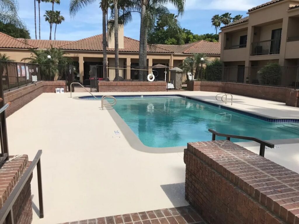 Pool deck coating around a backyard pool