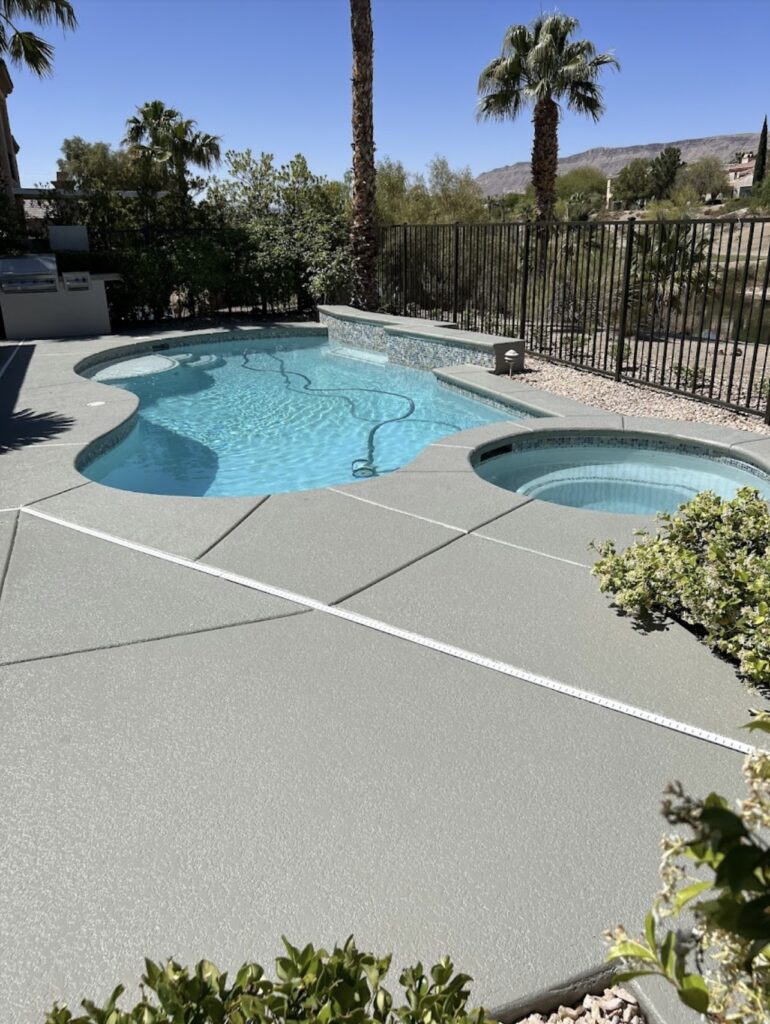 Pool deck coating around a backyard pool