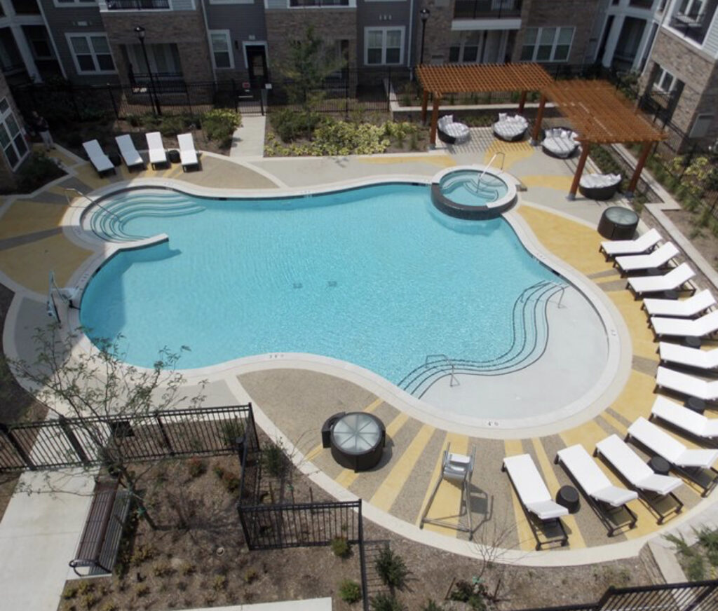 Pool deck coating around a backyard pool